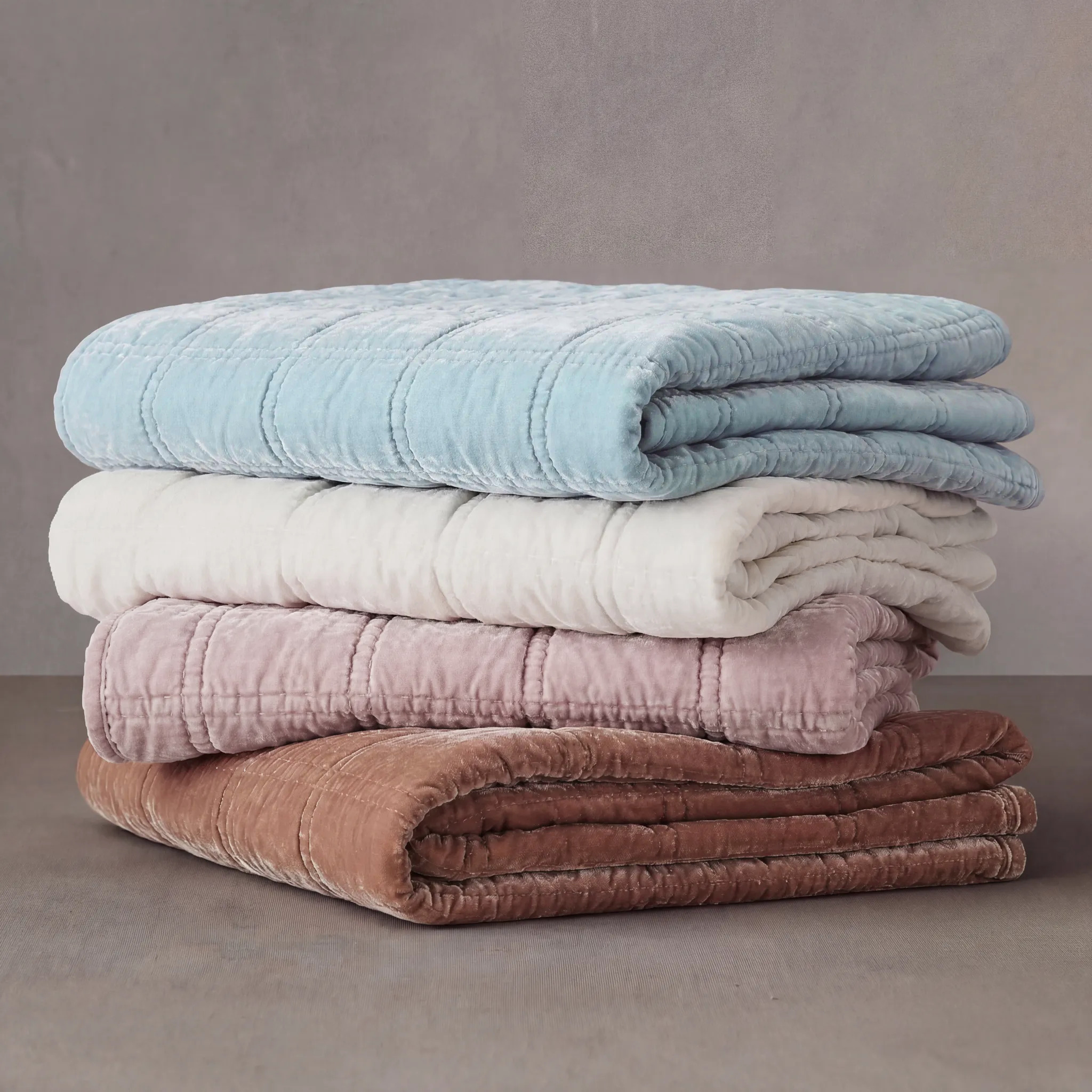 Plush faux silk velvet with a lustrous sheen and double box stitching. Elegant for layering and cozy warmth, available in neutral and jewel tones.