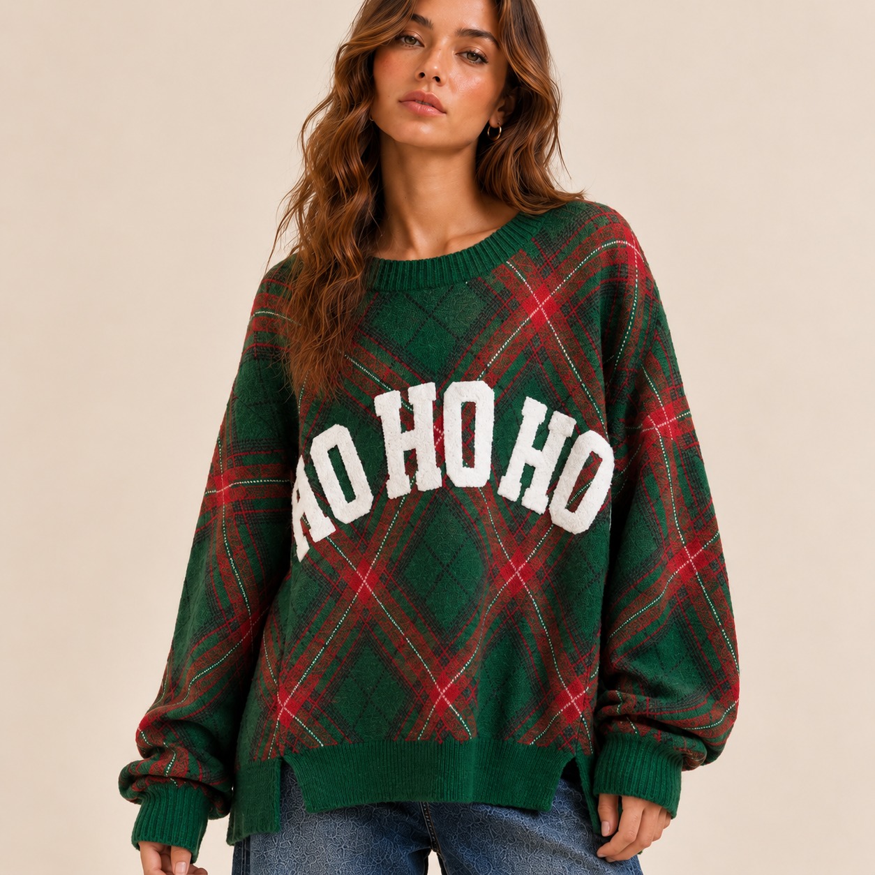 Festive plaid sweater featuring textured “HO HO HO” lettering across the front. Designed with a crew neckline, drop shoulders, long sleeves, ribbed trim, and a relaxed cozy fit.