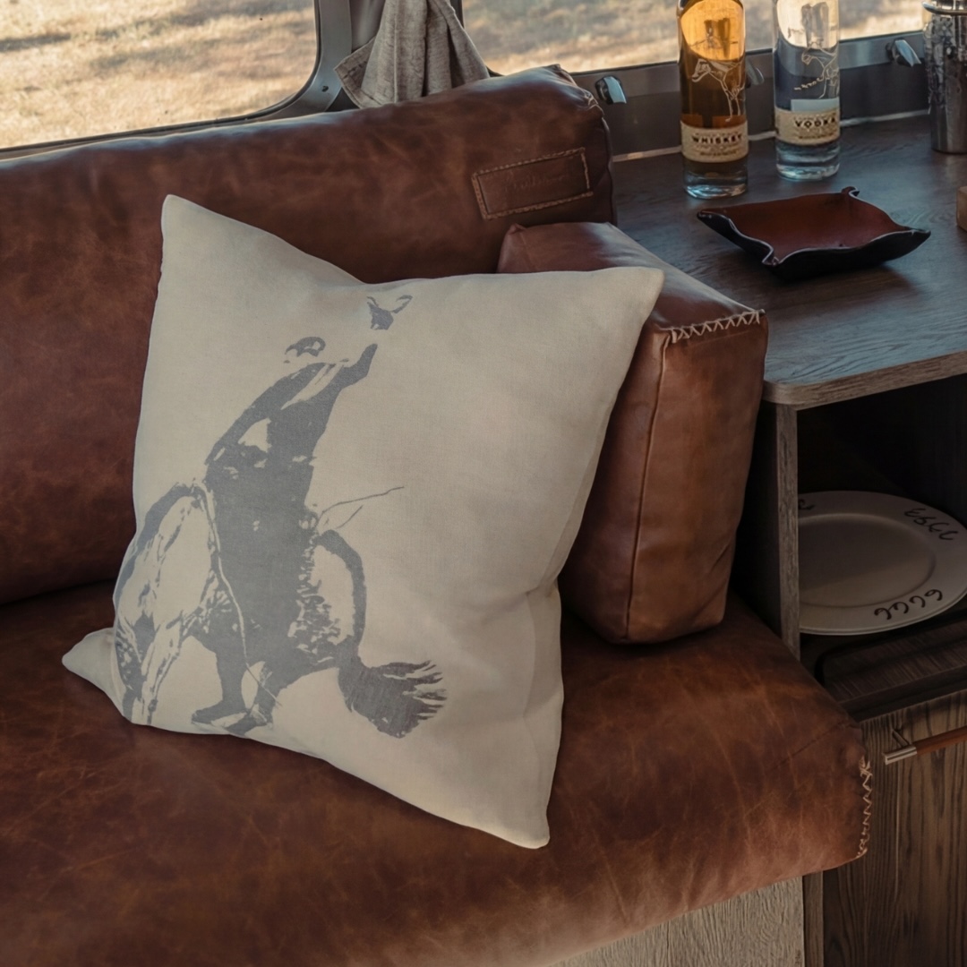 The iconic bucking bronc appears in sculptural, woven detail. Plush cotton chenille gives soft, substantial support for lounging or reading.