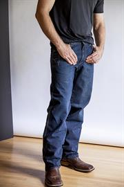 A mid-rise, relaxed upper thigh and bootcut leg. A dark wash denim featuring hand-sanded details, brown weft, and out signature knife pocket.