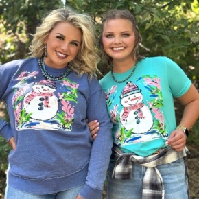 It's Frosty the Snowman!! Nothing makes your heart smile more than a perfectly painted snowman!  Shown on a Bella Canvas sea green t-shirt and our blue oversized poncho sweatshirt.