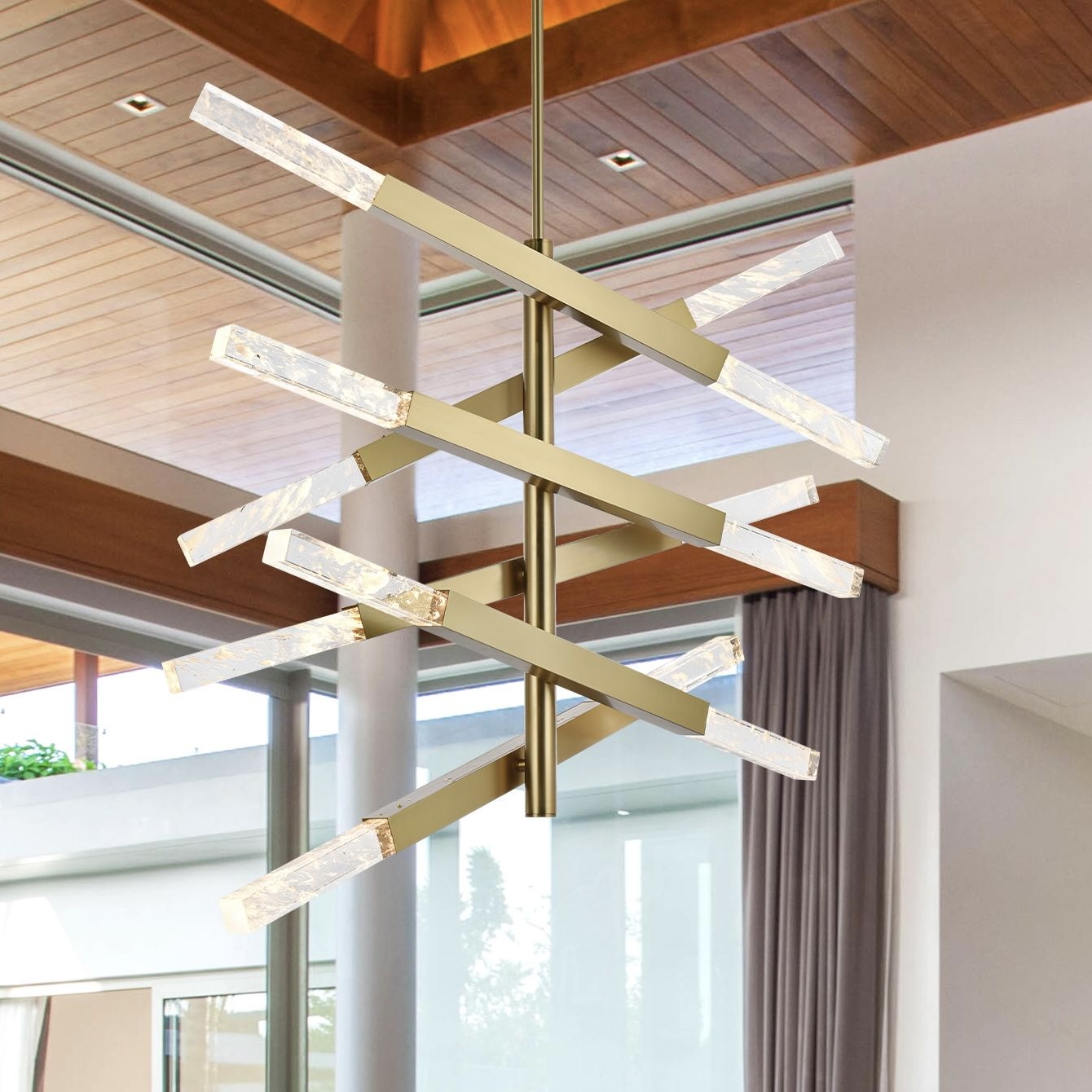 A Sleek Pendant Light Featuring a Satin Gold Frame Paired With Clear Crystal Elements.