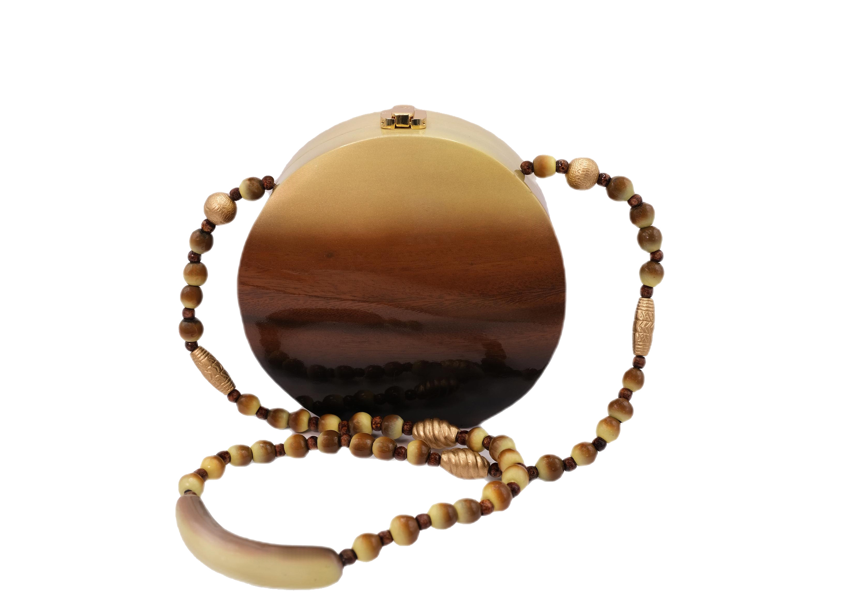 Refracted circle shape. Handmade from carved acacia wood.