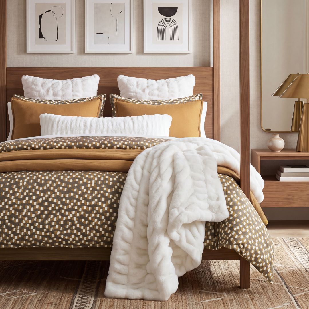 Hand-painted brush marks and block-printed textiles inspired the Sloane Modern Jacquard Bedding Set, where a scattered motif of antique gold and ivory drifts across a warm greige ground.