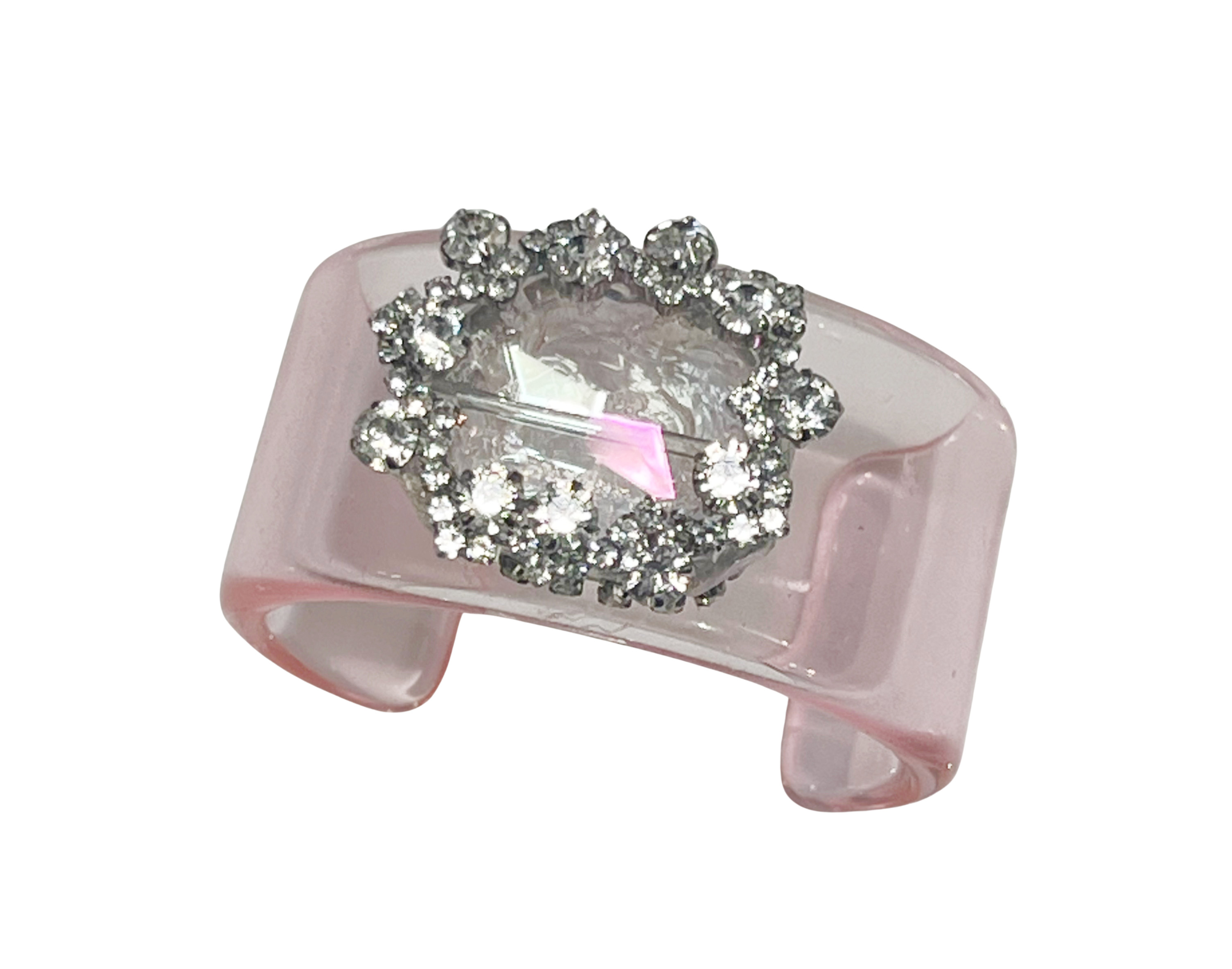 The Gilded Crown in Pink is a statement-making hard acrylic bracelet that combines bold design with playful elegance. 