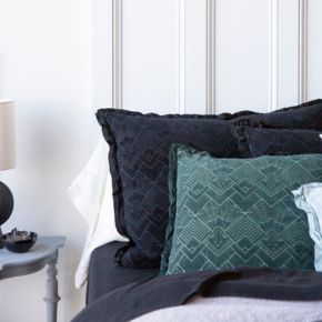 Two trettino shams in black and dark green shown upright against one another