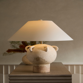 An antique olive vessel from the Mediterranean informed the classical shape and the Tuscan washed finish of this terracotta lamp.