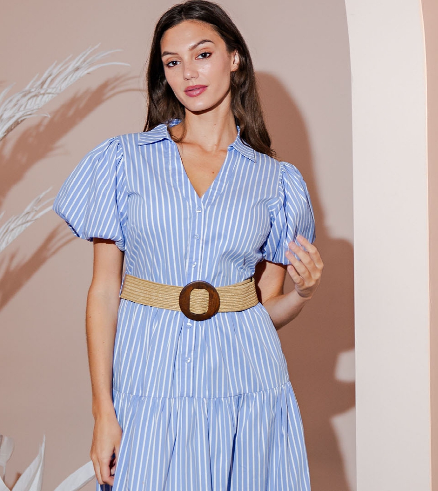 Blue and white striped midi dress featuring puff sleeves, a button-front bodice, and a softly tiered skirt for a feminine, polished silhouette ideal for modern boutiques.