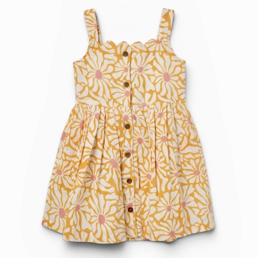 Handcrafted girls’ cotton dress with hand block-printed florals, scallop neckline, adjustable straps, lining and pockets. Ethically made with natural dyes; 3% supports women’s empowerment.