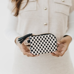 The Paris Wallet, crafted from durable pebbled and woven vegan leather, offers stylish everyday functionality with spacious storage and an O-ring for easy clipping to your favorite Pretty Simple bag.