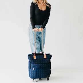 The Tenley Quilted Tote Roller Bag is a stylish, functional puffer nylon tote designed for life on the go, featuring multiple compartments and a trolley sleeve for easy wheeling. 
