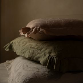 A stack of three Marisette Throw Pillows
