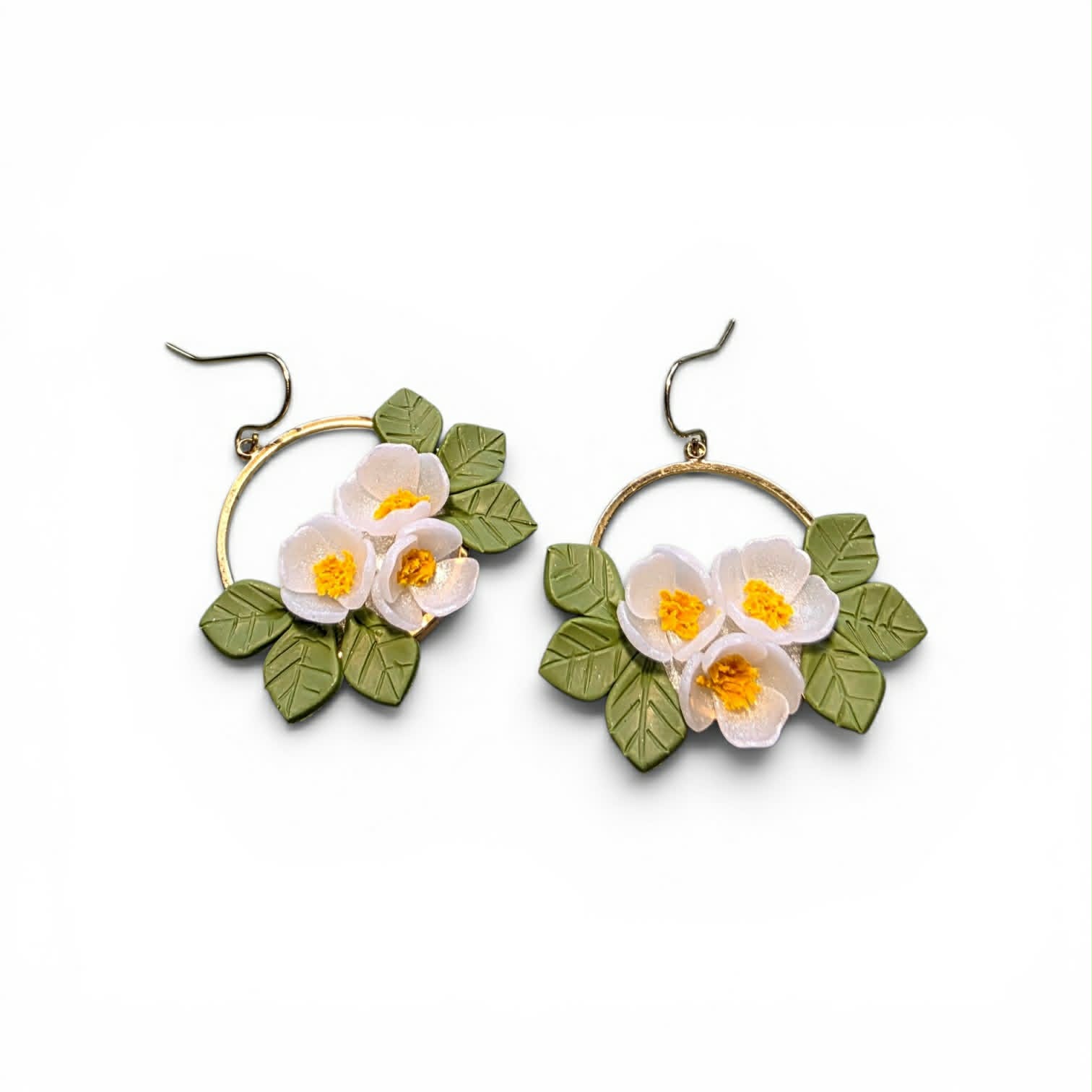 Handcrafted polymer clay earrings from the Grounded Bloom Collection, with sculpted flowers and leaves in symbolic shades of black, terracotta, and white. Lightweight, botanical, and full of meaning.