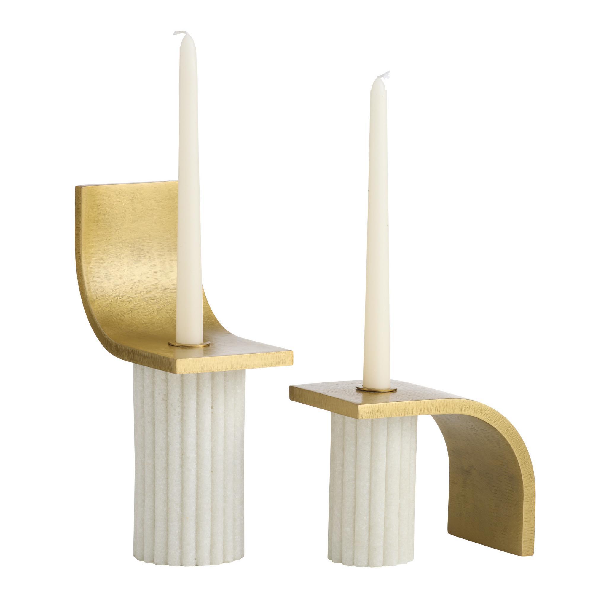 This staggered set, a modern twist on classical iconography, was informed by Greek columns and arches. Crafted of ivory ricestone composite, the pair securely holds a taper candle.