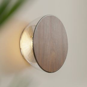 Ramen Mini is a 6-inch architectural wall sconce for indoor and outdoor use, featuring interchangeable and custom laser-cut plates for wayfinding, branding, and soft ambient light.