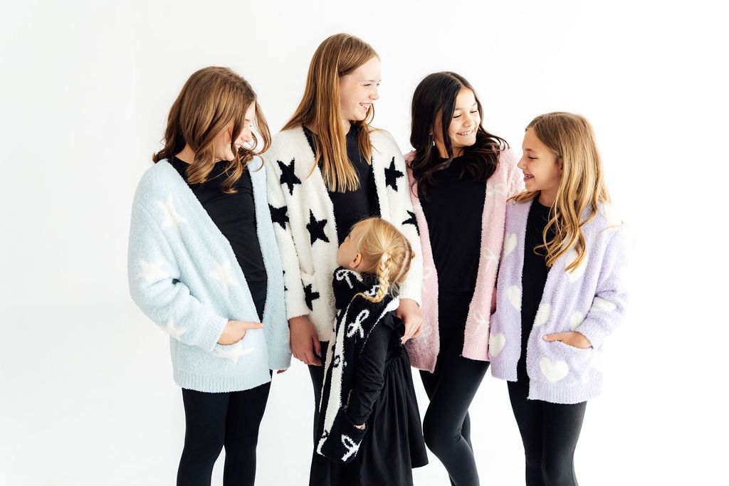Our cozy collection- soft, snuggly, and perfect for cuddles or chilly day adventures! Featuring a soft cardigan, fluffy socks, cozy beanie, and a snuggly blanket.