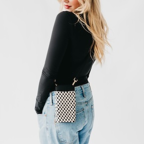 The Woven Double Duty Phone Bag keeps essentials close with an outer phone pouch and interior compartments for cash, cards, and coins.