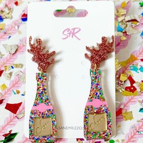 Each pair features a charming acrylic champagne bottle adorned with colorful confetti dots, topped with elegant rose gold bubble accents that catch the light beautifully.