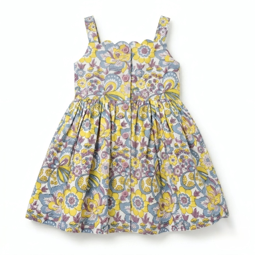 Handcrafted girls’ cotton dress with hand block-printed florals, scallop neckline, adjustable straps, lining and pockets. Ethically made with natural dyes; 3% supports women’s empowerment.
