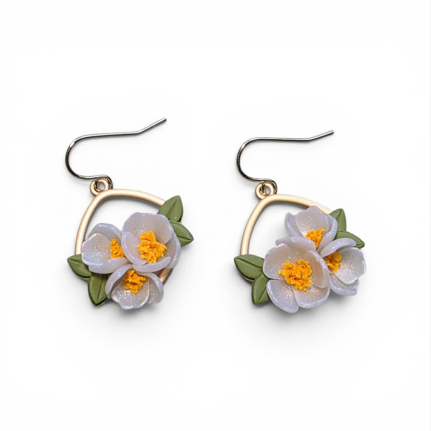 Handcrafted polymer clay earrings from the Grounded Bloom Collection, with sculpted flowers and leaves in symbolic shades of black, terracotta, and white. Lightweight, botanical, and full of meaning.
