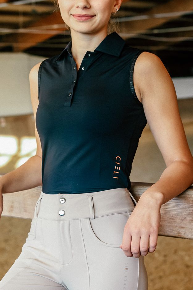 A refined sleeveless riding polo with lightweight stretch fabric, laser-cut ventilation and a flattering athletic fit. Polished and breathable for warm-weather riding.