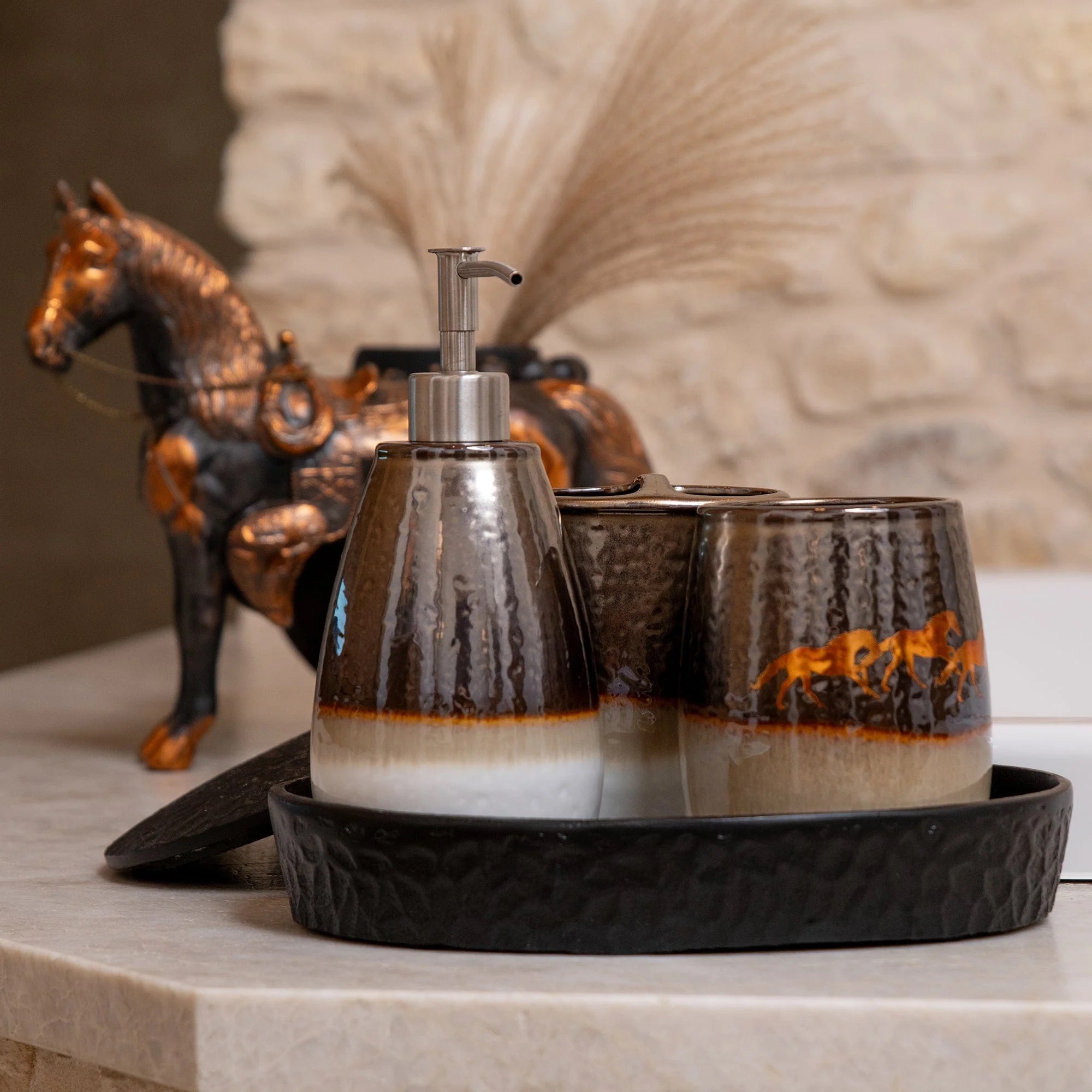 A free-spirited remuda of metallic horses runs across an earth-tone horizon in this set, imparting an elegant rustic charm to your bathroom countertop.