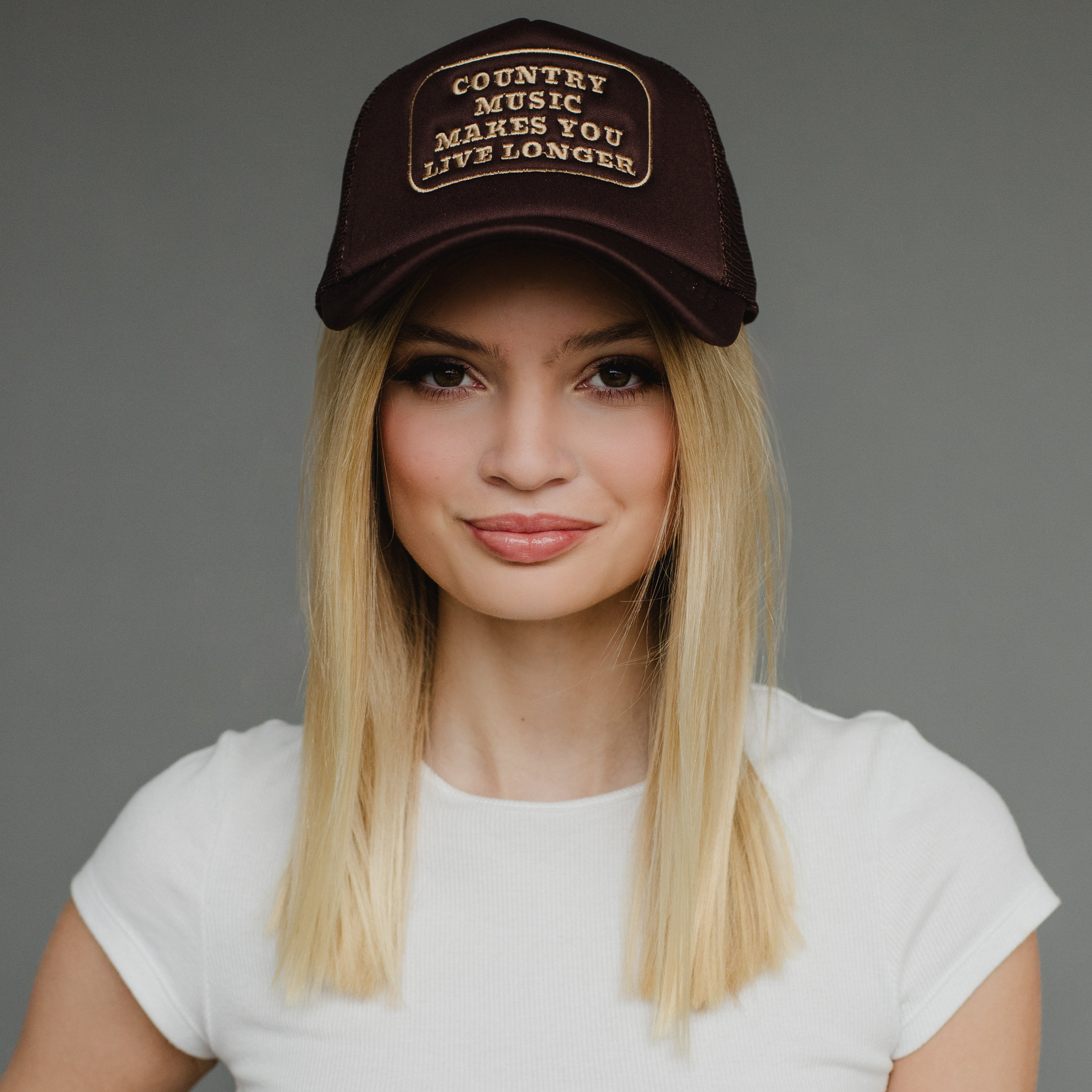 Brown trucker hat  Tan "Country music makes your live longer" embroidered on front  100% Polyester  Adjustable snapback closure  Breathable mesh  Min. Qty. 2